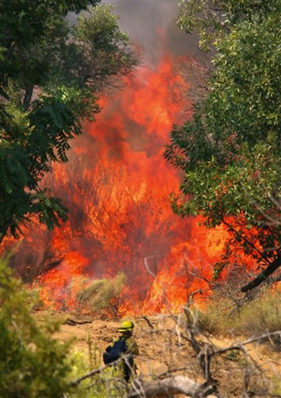 A Kern County firefighter keeps an eye on a backburn operation Wednesday in Lake Isabella, Calif. A wildfire in the southern Sierra Nevada has forced evacuations in some communities along the Lower Kern River Canyon.